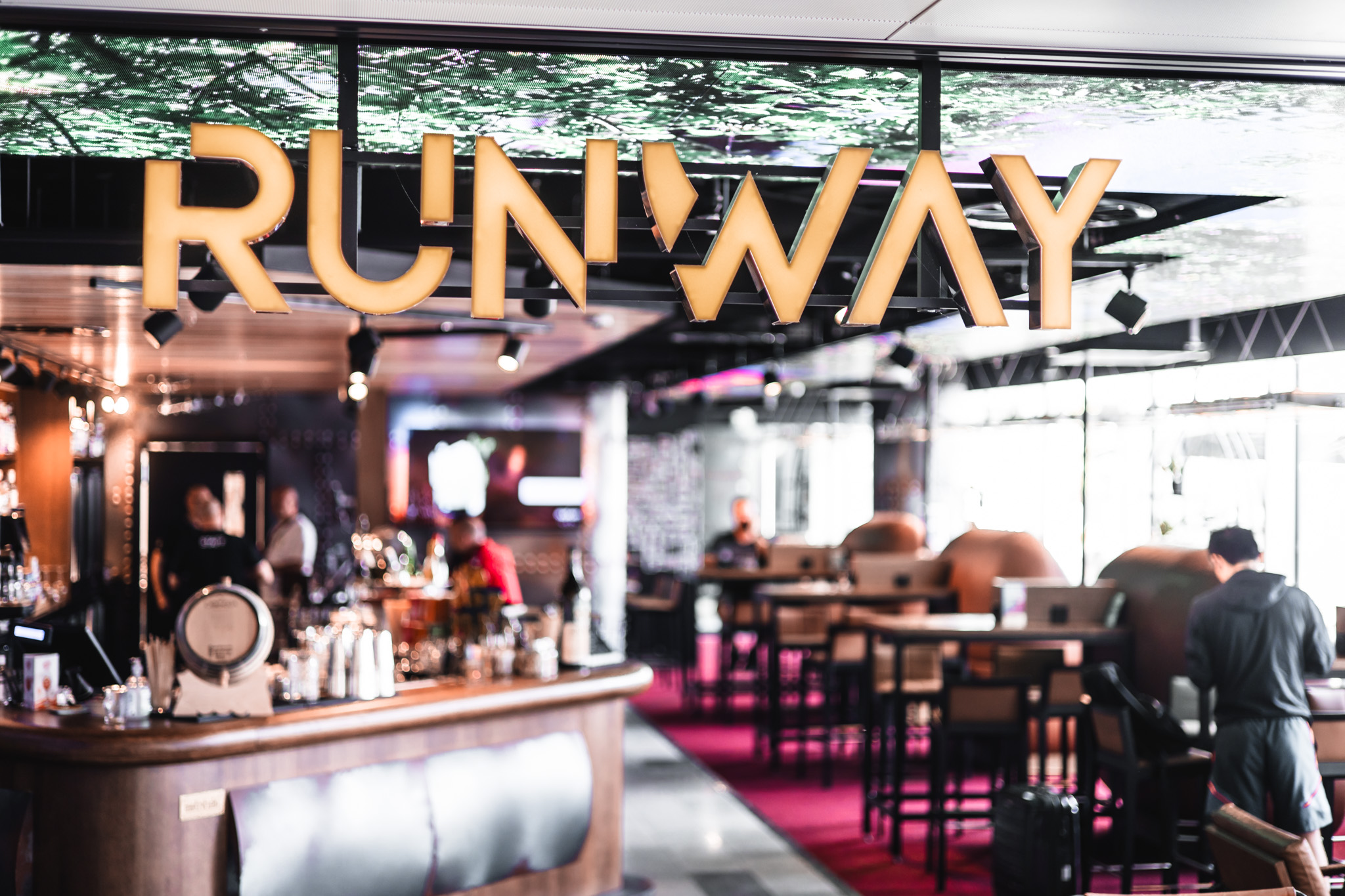 Runway Bar interior — the RUNWAY sign