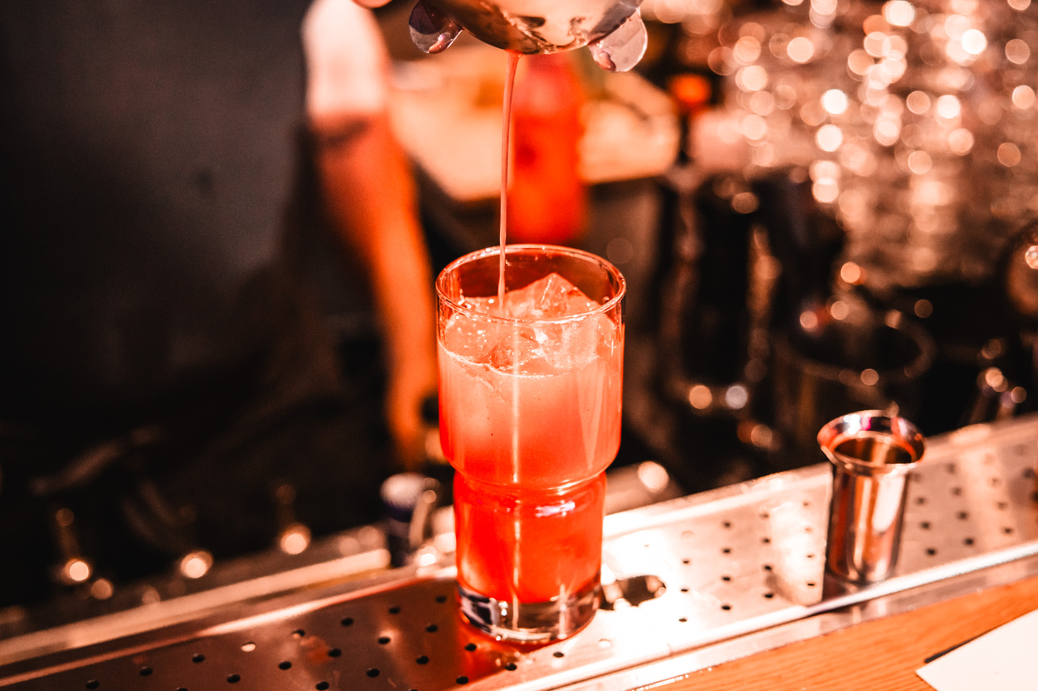 Red cocktail pour under stage lights